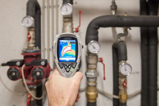 Plumber using a thermal imaging camera to inspect pipes in Brentwood