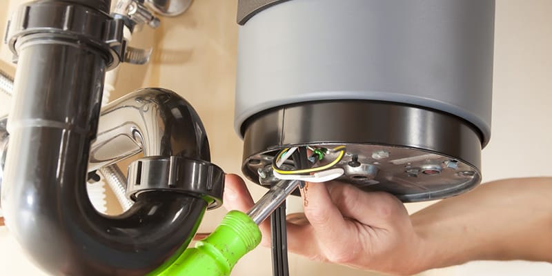 Technician repairing the heating element of a water heater in Brentwood