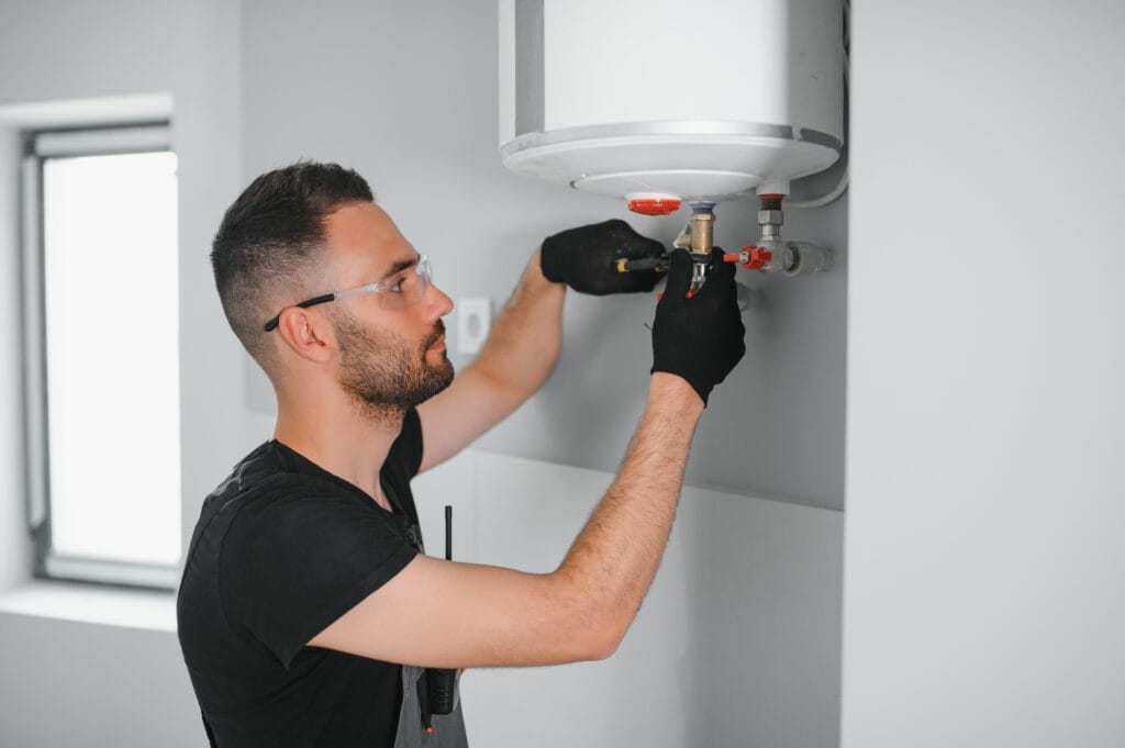 Technician performing water heater maintenance in Brentwood