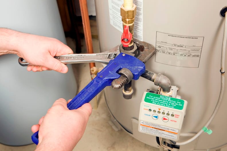 Plumber repairing a water heater valve in Brentwood